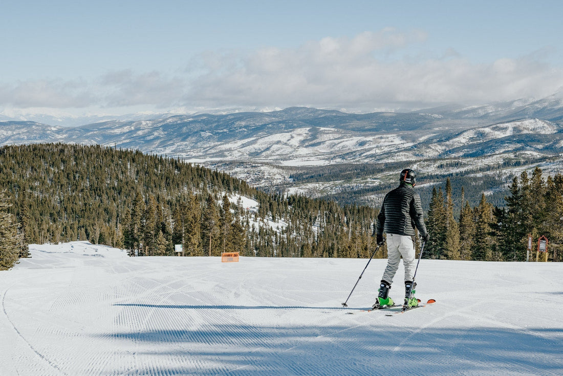 Ski instructor coaching a beginner skier on a green run